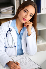 Female doctor hold hold in arm silver pen and pad during ward round check portrait. Medic exam aid visit and remedy prescribe for sick office business visitor with problem and complaint for anamnesis