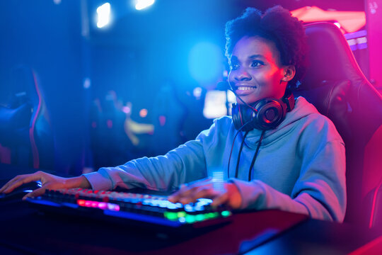 Professional Streamer African young woman cyber gamer in neon color blur background