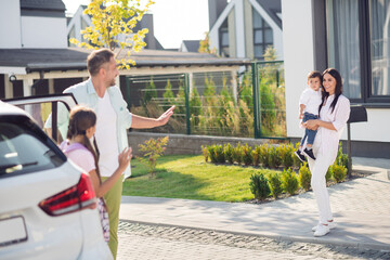 Photo portrait of big family meeting after school and work waving hands saying hi outdoors on street in summer