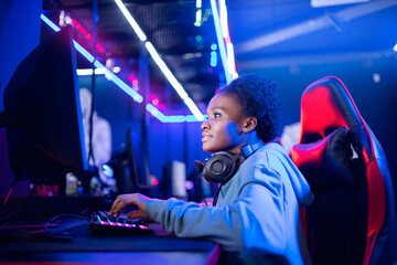 Portrait Gamer African American beautiful woman play online games computer, streamer neon