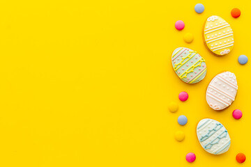 Top view of Easter cookies eggs and sweets. Space for text