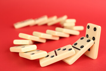White domino tiles falling on red background