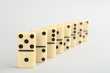 Row of domino tiles on white background