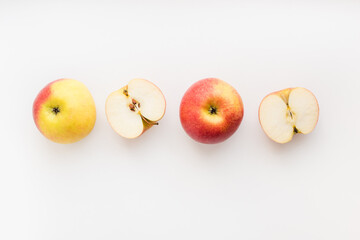 red apples on white background, halves of apples on a white background