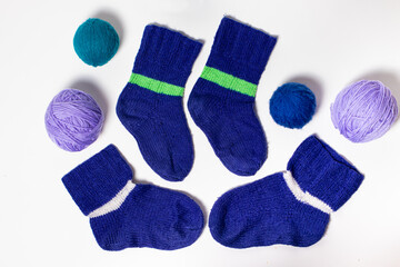 Blue knitted wool socks. Balls of multicolored yarn for knitting, handicrafts and hobbies