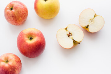 red apples on white background, halves of apples on a white background