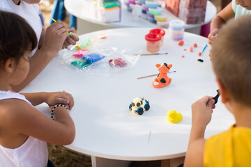 Children's hands mold from plasticine.