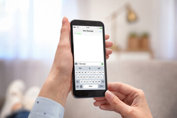 Woman sending message with text I Love You, closeup