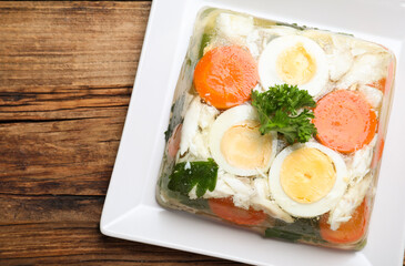 Delicious fish aspic served on wooden table, top view