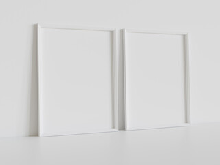 Two white frames leaning on white floor in interior mockup. Template of pictures framed on a wall 3D rendering