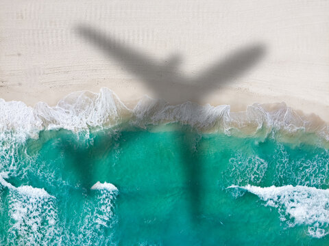 Drone photo of empty Playa Ballenas with large airplane shadow, Cancun, Mexico