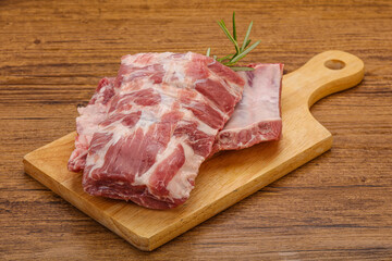 Raw pork ribs served rosemary