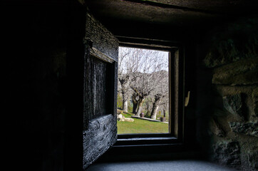 Fototapeta na wymiar Interior view from the window of a rustic house towards a beautiful garden with trees