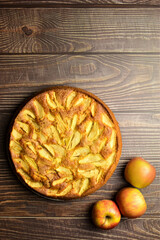 Banner, homemade apple pie on brown table. Space for text or idea.