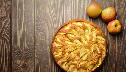 Homemade apple cake on rustic brown wooden table