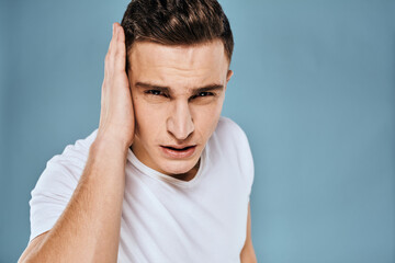 emotional displeased man cropped view white t-shirt blue background