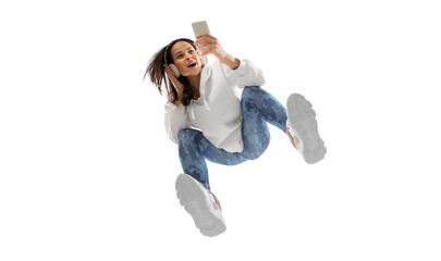 Scrolling phone. Young stylish woman in modern street style outfit isolated on white background,...