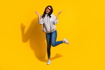 Full body photo of dark skin woman raise hands leg cheerful happy mood isolated on yellow color background