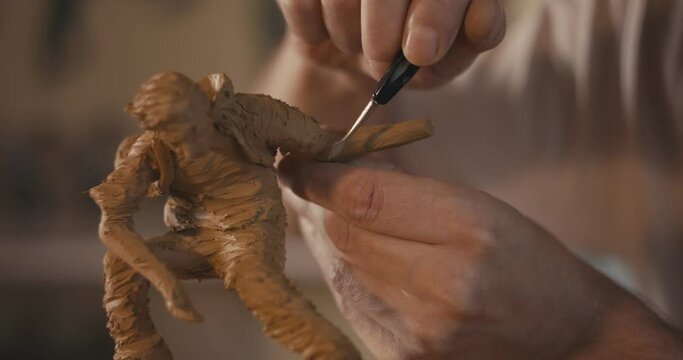 Artist shape clay hand sculpting art precise detail atudio close up