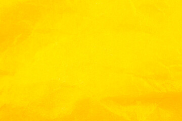 Crumpled yellow paper background. Real macro battered texture. Close up photo.