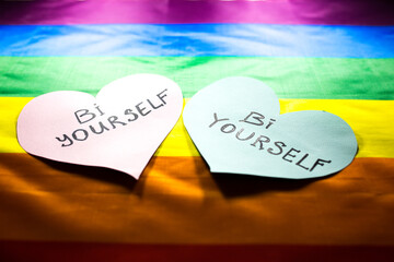 Lgbt community colorful flag. Bi yourself signs on hearts on rainbow background. Lesbian, gay and...