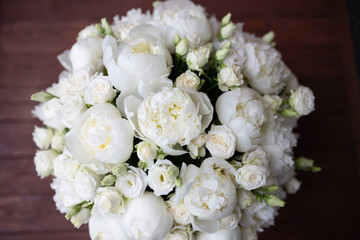 White peonies collected in a composition. Fresh, natural flowers, on a dark background