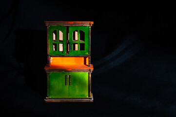 Cupboard, toy wooden furniture on dark background