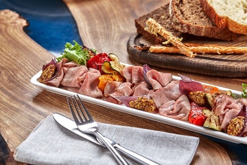 Sliced Beef or Pork with Marinated Vegetables and Sauce. Beautifully decorated catering banquet menu. Food snacks and appetizers for buffet on white background