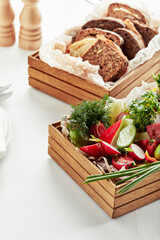 chopped fresh vegetables in a wooden box on a white background. Banquet festive dishes. Gourmet restaurant menu.