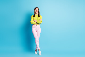 Fototapeta na wymiar Full size photo of young pretty woman folded arms confident look empty space isolated over blue color background
