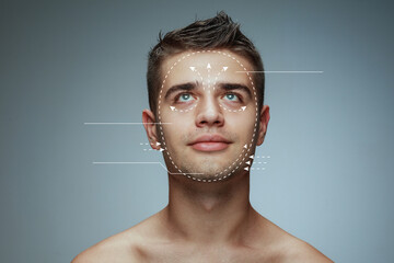 Beautiful male face with lifting up arrows isolated on grey background. Concept of bodycare,...