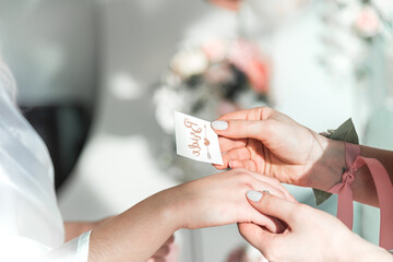 The process of sticking a temporary tattoo on the arm of the bride in the style of a bachelorette party.