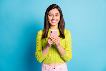 Photo of young attractive girl cheerful positive smile use cellphone mobile chat type browse...