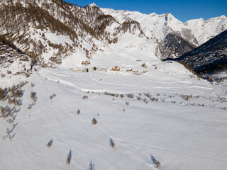 Fototapeta na wymiar Daylight drone shot in mountain landscape with snow. Alps, Italy. Aerial view. 