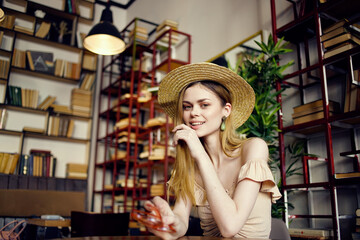 beautiful woman in a hat sitting at a table in a cafe vacation book fun