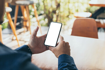 cell phone blank white screen mockup.man hand holding texting using mobile on desk at office.background empty space for advertise.work people contact marketing business,technology