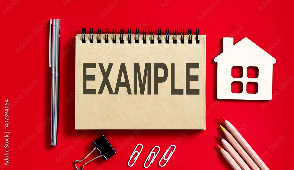 Poster example text written on a notebook with pencils and office tools and model wooden house