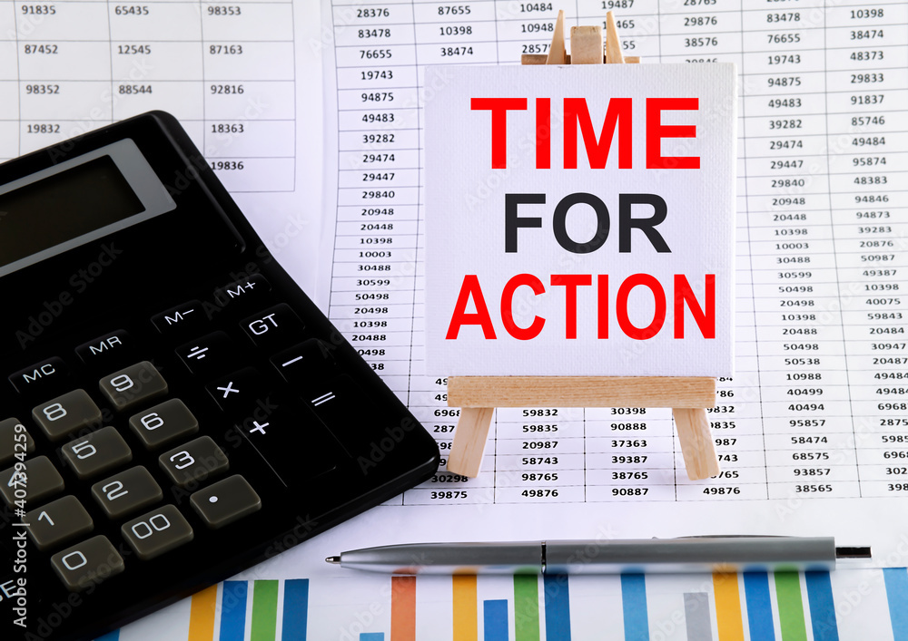 Poster time for action on small easel with charts, pen and calculator.business concept.