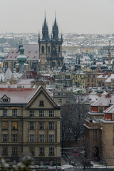 Historical center of Prague covered in the first snow of the winter.