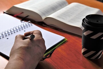 person writing on a notebook