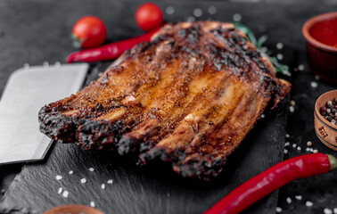 grilled pork ribs on a stone background	