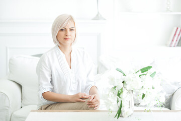 Closeup portrait of midadult blond woman indoors