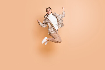 Full size profile photo of impressed nice girl jump wear white shirt trousers sneakers isolated on beige color background