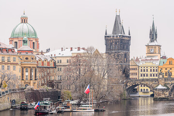 Fototapeta premium Historical center of Prague covered in the first snow of the winter.