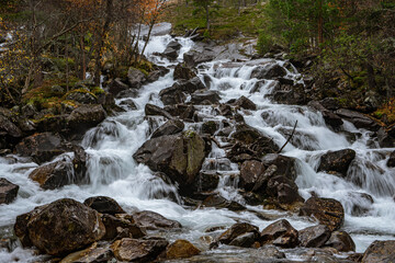 Flat waterfall with many stones in Norway