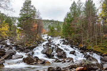 Flat waterfall with many stones in Norway