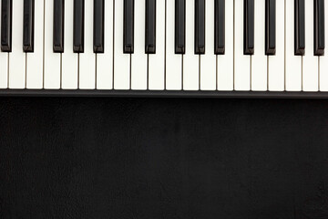 Fototapeta premium Desk of musician for songwriter work set with headphones and synthesizer