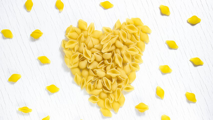 Macaroni on a white background in the shape of a heart. Love of pasta.