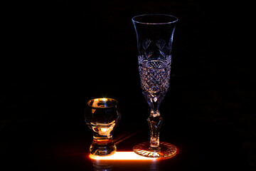 Glasses for wine and champagne and glasses for strong drinks on the bar.