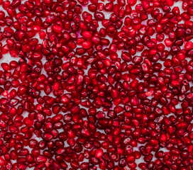 Red pomegranate seeds on a white background. Close-up. Fruit, food. Photophone, wallpaper, texture,...